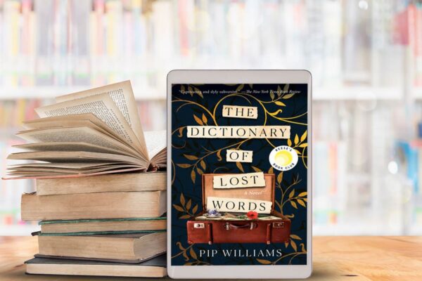 The Dictionary of Lost Words book club questions. with ipad and a stack of books