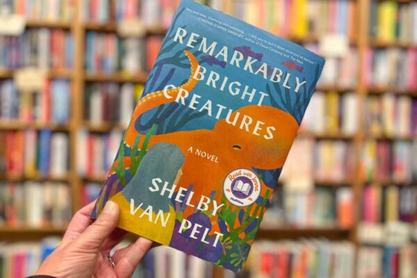 Remarkably Bright Creatures book club questions, with book cover and bookshelves in background.