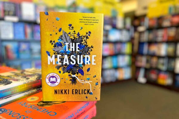 The Measure book club questions, with book cover and bookshelves.